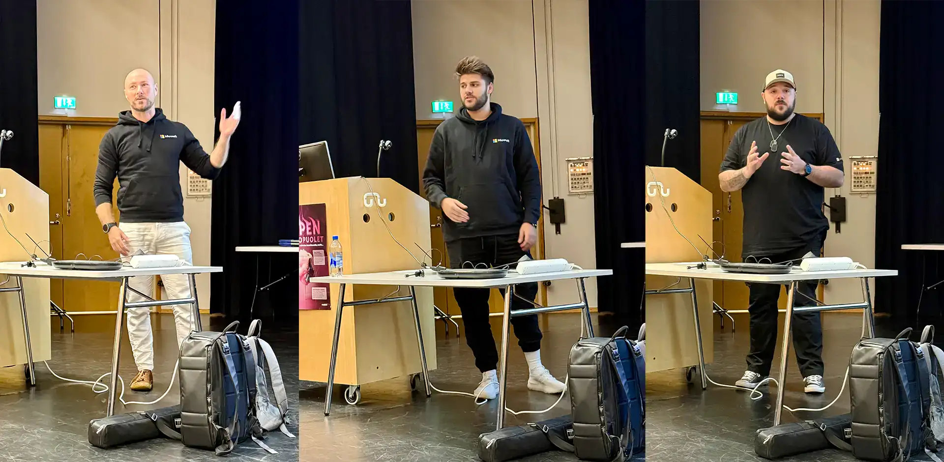 Kolme henkilöä, joilla mustat hupparit päällä.