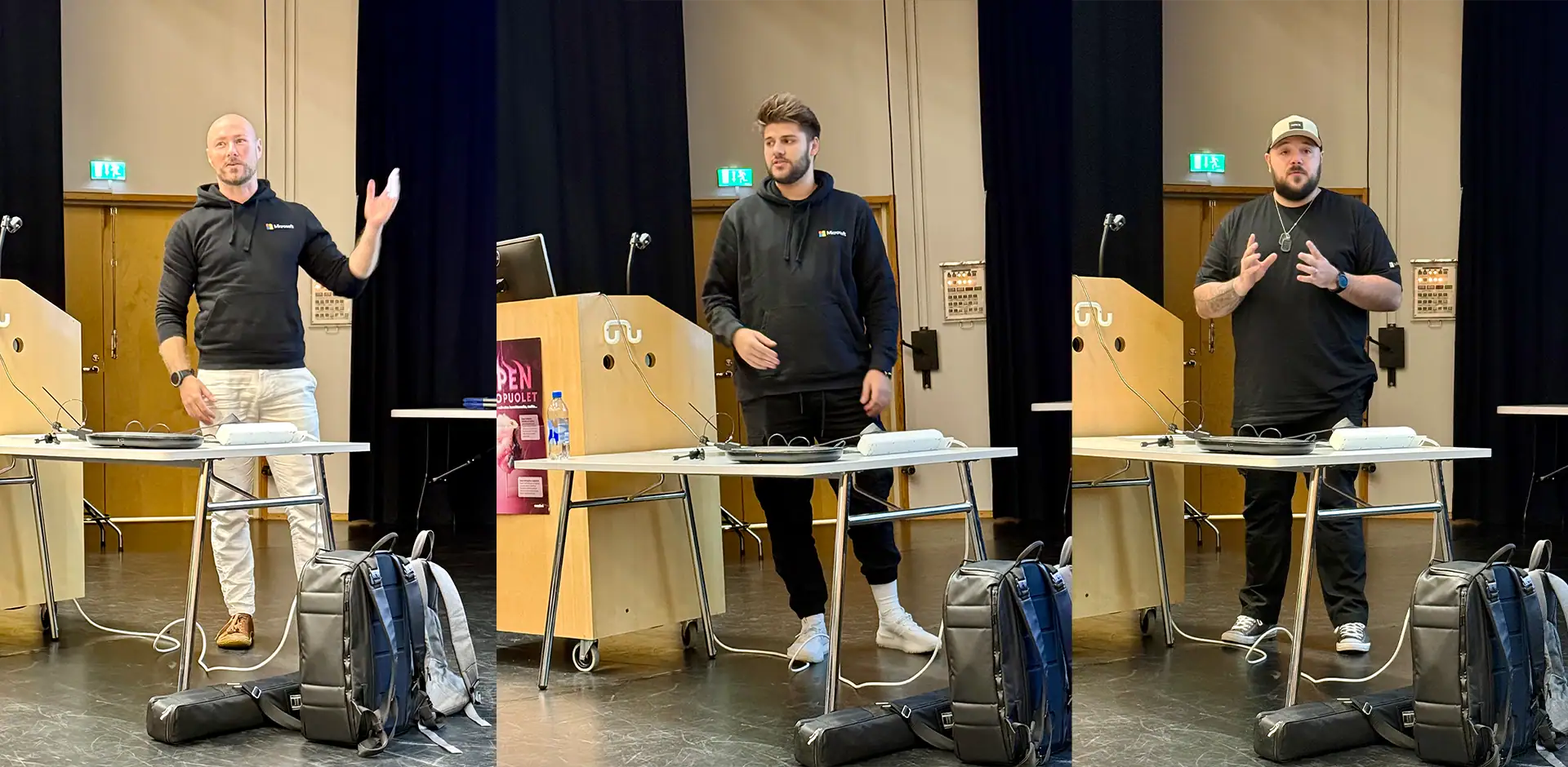 Kolme henkilöä, joilla mustat hupparit päällä.